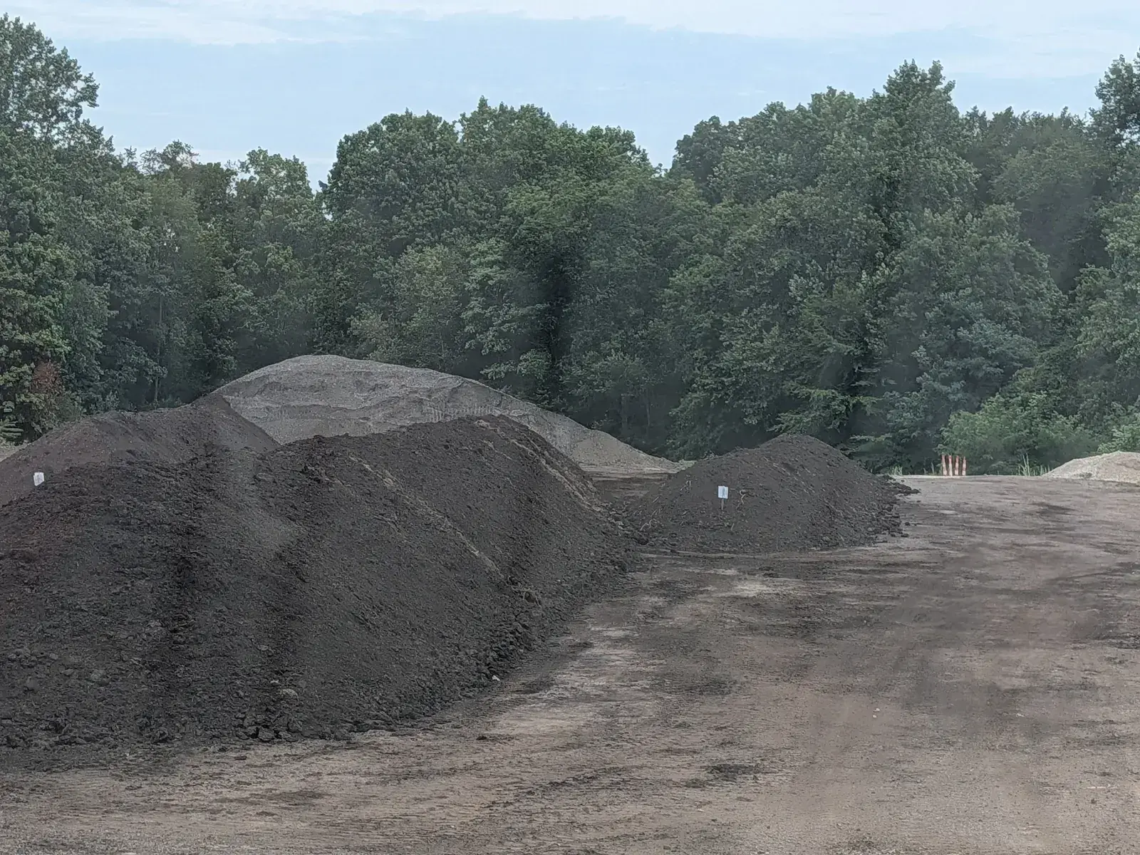Stockpiles of dark screened material at the O'Bryan yard on Seasons Road in Stow, Ohio